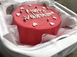 Homemade bread with happy valentine lettering in red. photo