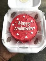 Homemade bread with happy valentine lettering in red. photo