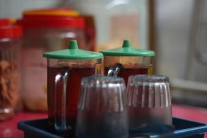 two glasses of sweet tea on a wooden table. photo