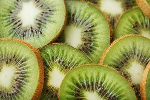 Kiwi fruit cut into slices, in full screen as a background. photo