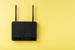 Router wireless LAN technology with devices based on IEEE 802.11 standards on a yellow background free space top view. photo