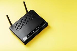 Black Wi-Fi router on a yellow background with free space. photo