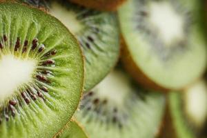 Kiwi fruit cut into slices, in full screen as a background. photo