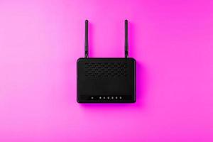 Router with wireless LAN technology with devices based on IEEE 802.11 standards on a pink background, top view of free space. Isolte photo
