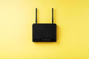 Black Wi-Fi router on a yellow background with free space. photo