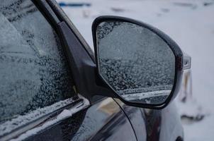 car mirror froze on the street in winter photo