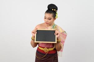 Young beautiful woman in northeastern dress holding chalkboard posting photo