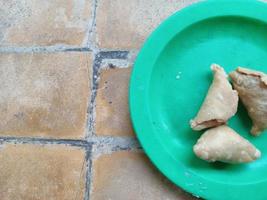 three delicious dumplings on a green plate ready to eat photo