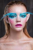 Young charming blonde with creative makeup photo