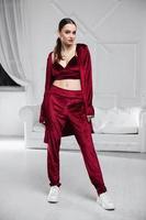 Alluring brunette dressed in a burgundy velour suit photo