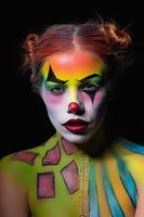 Attractive woman with a body art clown photo