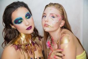 Two lovely young women with creative make-up photo