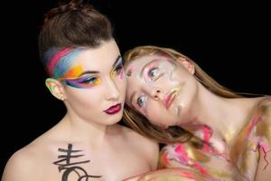 Two cute young women with creative make-up photo