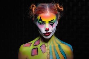 Sexy young woman with a face painting clown photo