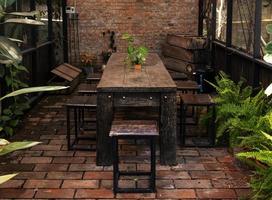 Outdoor retro wooden table and chair in garden photo