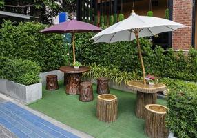 Outdoor wooden table and chair in garden photo