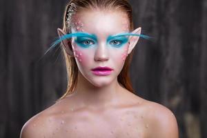 Young lovely blonde with creative makeup photo