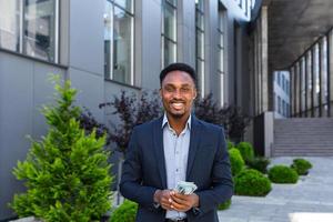 Happy successful African American businessman counts, waves, throws, show off photo