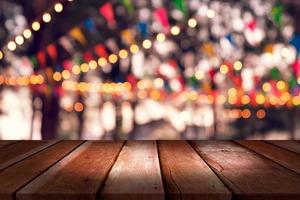 top desk with blur restaurant background,Wooden table and blurred bokeh of night street background photo