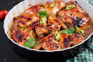 Baked chicken wings in the Asian style on baking dish. photo