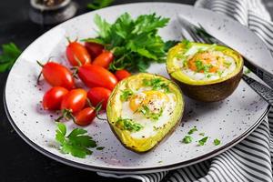 Avocado baked with egg and fresh salad. Vegetarian dish. Ketogenic diet. Keto food photo