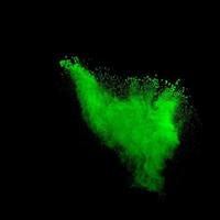 Green dust explosion on black background. Colored powder splatter on background. photo