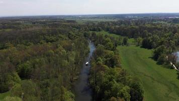 Aerial view of a tourist boat on water channel in park Lednice video