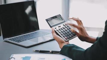 Financial analysts analyze business financial reports on a digital tablet planning investment project during a discussion at a meeting of corporate showing the results of their successful teamwork. video