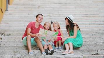 Family vacation in Europe. Parents and kids with touristic map searching the attractions. video