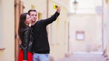 Selfie photo by caucasian couple traveling in Europe. Romantic travel woman and man in love smiling happy taking self portrait outdoor during vacation holidays video