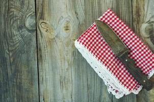 old kitchen knife on a red napkin, empty space on the left photo