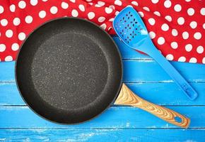 empty black round nonstick frying pan with handle photo