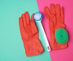 items for home cleaning red rubber gloves, brush, green sponge for dusting photo
