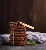 a stack of round chocolate cookies tied with a rope photo