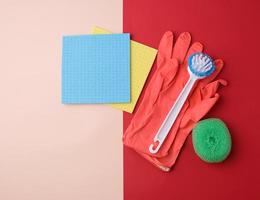 items for home cleaning red rubber gloves, brush, multi-colored sponges for dusting photo