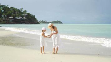 Family fun on white sandy beach. Mother and little kid enjoy summer vacation