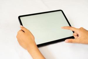 Hand holding blank digital tablet for mockups photo