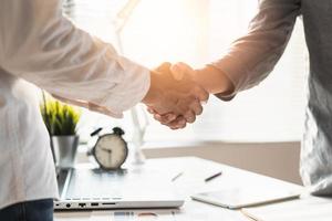 two businessmen handshaking in meeting after final project agreement deal done. photo