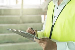 Builder inspection consultancy. Inspector checking material and structure in construction. photo