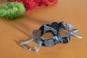 Venetian carnival mask, forming frame in one of the lower corners with space for text photo