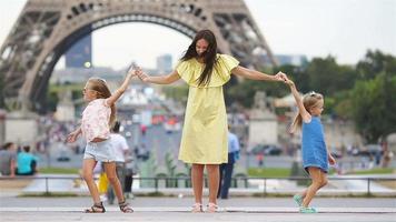 Happy family of mother and kids in Paris near Eiffel tower. French summer holidays, travel and people concept. European vacation video