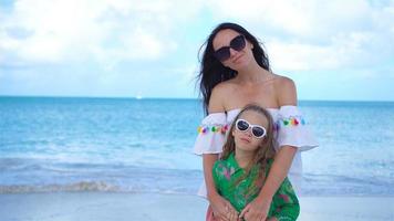 Beautiful mother and daughter on Caribbean beach. Portrait of family on summer vacation video