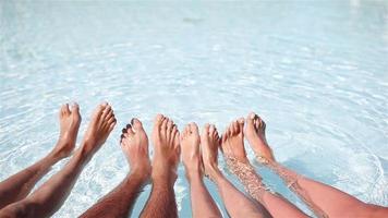 Close up of four people's legs by pool side video