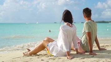 Young couple on white beach during summer vacation. Happy lovers enjoy their honeymoon at exotic island video