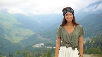 Beautiful happy young woman in mountains in the background of fog video