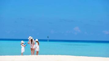 hermoso paisaje de playa tropical con familia en blanco disfrutando de las vacaciones de verano video