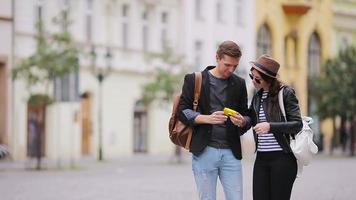 Romantic couple walking together and taking selfie in Europe. Happy lovers enjoying cityscape with famous landmarks. Stylish urban young man and woman with backpacks on travel. video