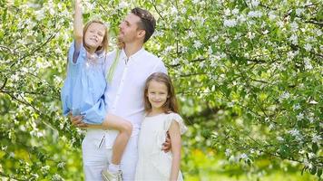 Happy family in blooming garden on beautiful spring day video