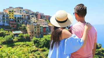 Happy couple with view of the old coastal village background of Corniglia, Cinque Terre national park, Liguria, Italy ,Europe video