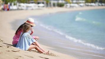 Family of mom and kid enjoy the sea view on white beach video